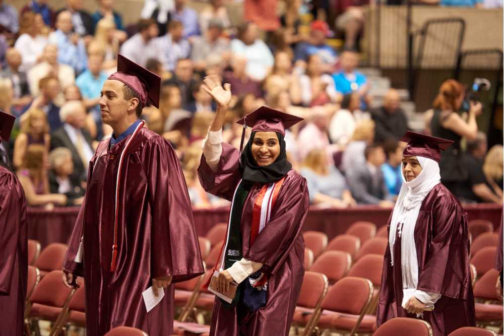 Graduates walking into Commencement